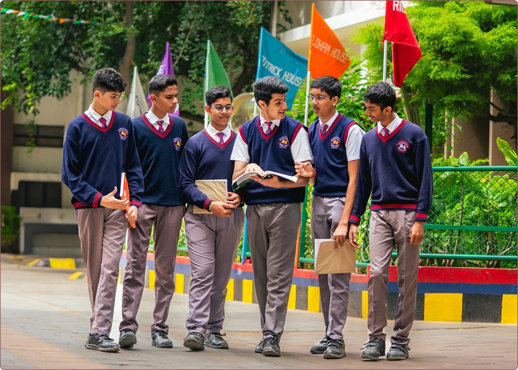 Baldwin Boys' High School students walking on a beautiful green lawn, representing excellence in education and campus life
